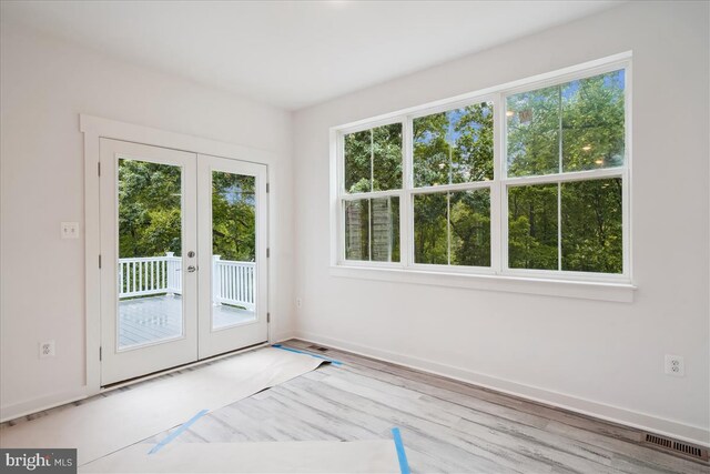 9842 Fire Tower Rd, Ijamsville, MD 21754 - doorway to outside featuring french doors, wood finished floors, and baseboards