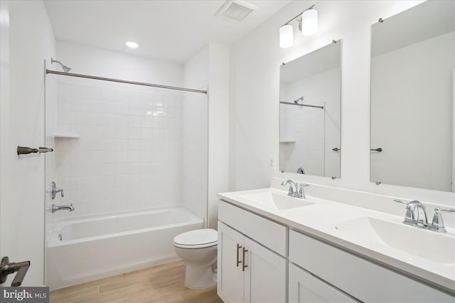 9842 Fire Tower Rd, Ijamsville, MD 21754 - bathroom featuring wood finished floors, toilet, double vanity, and tub / shower combination