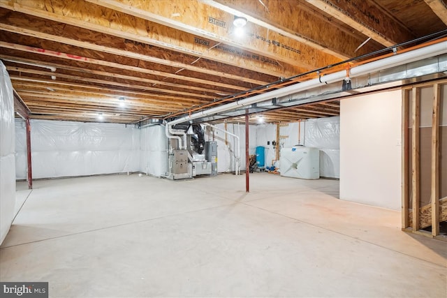 9842 Fire Tower Rd, Ijamsville, MD 21754 - unfinished below grade area featuring heating unit, washer and clothes dryer, and a water pressure tank