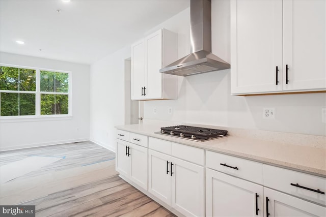 9842 Fire Tower Rd, Ijamsville, MD 21754 - kitchen featuring wall chimney exhaust hood, stainless steel gas cooktop, light wood-style flooring, white cabinets, and recessed lighting