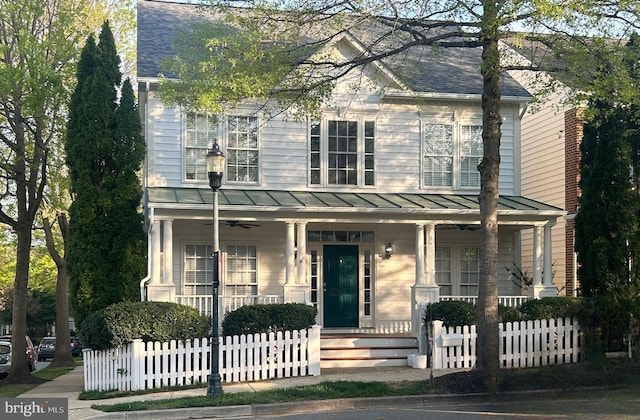 view of front of property featuring a porch, a ceiling fan, a fenced front yard, and a standing seam roof