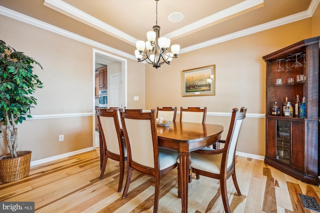 502 Leaning Oak St, Gaithersburg, MD 20878 - dining room featuring a chandelier, light wood-type flooring, a raised ceiling, crown molding, and baseboards