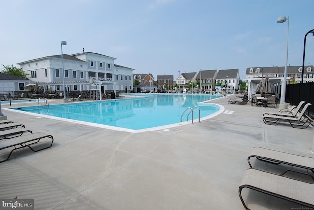 502 Leaning Oak St, Gaithersburg, MD 20878 - community pool featuring a patio area, fence, and a residential view