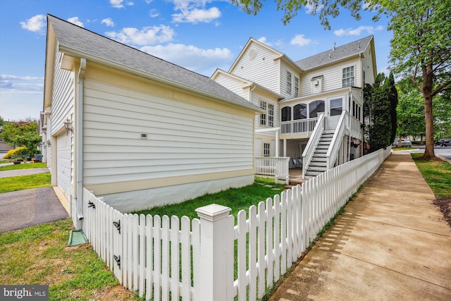 502 Leaning Oak St, Gaithersburg, MD 20878 - back of property featuring a sunroom, stairs, a shingled roof, and a garage