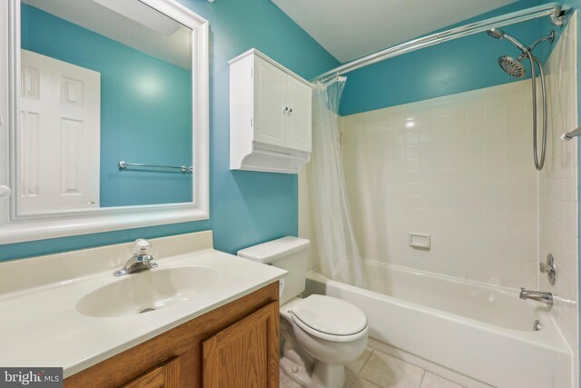 bathroom featuring tile patterned floors, shower / tub combo, vanity, and toilet