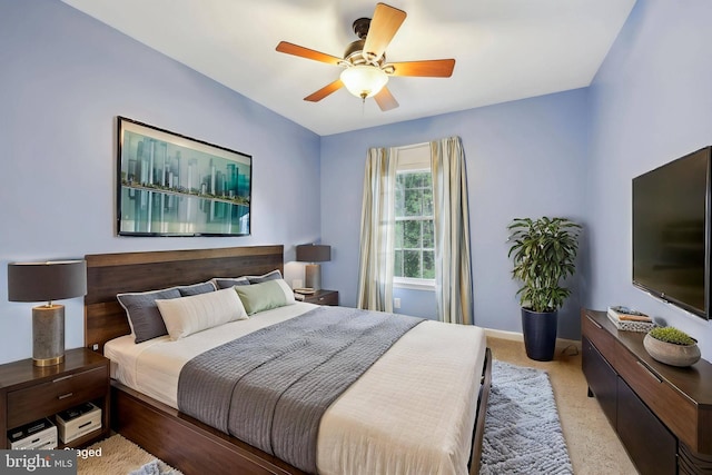 bedroom featuring baseboards, a ceiling fan, and carpet