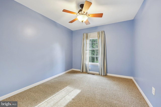 empty room featuring baseboards, visible vents, ceiling fan, and carpet flooring