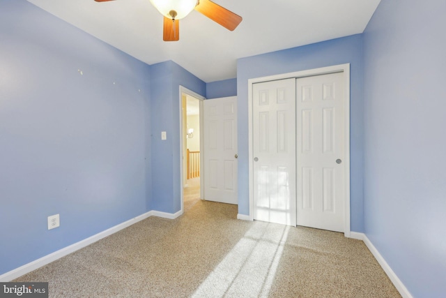 unfurnished bedroom featuring carpet, baseboards, and a closet
