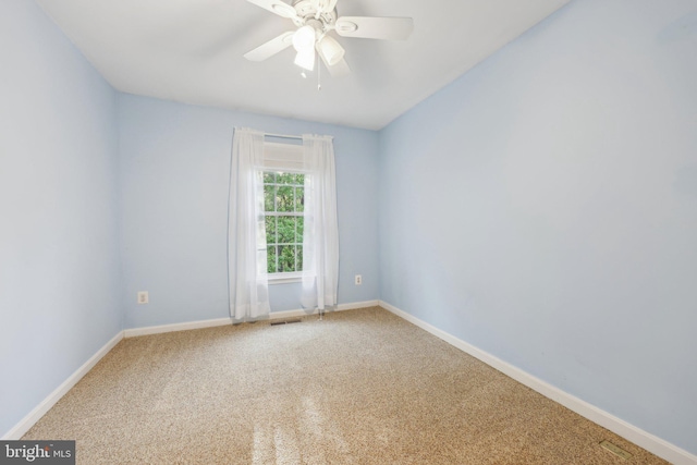 empty room featuring visible vents, ceiling fan, carpet floors, and baseboards