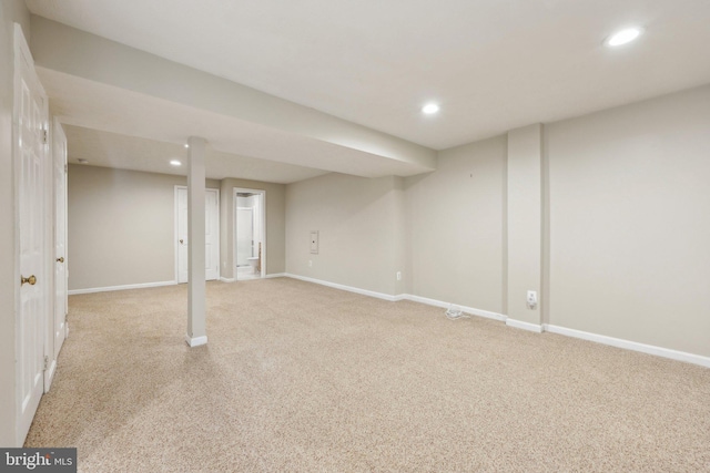 finished below grade area with recessed lighting, light colored carpet, and baseboards