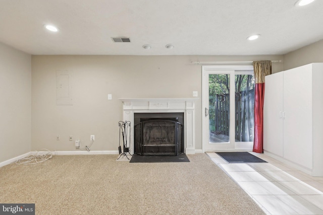 unfurnished living room with baseboards, recessed lighting, a fireplace with flush hearth, and carpet