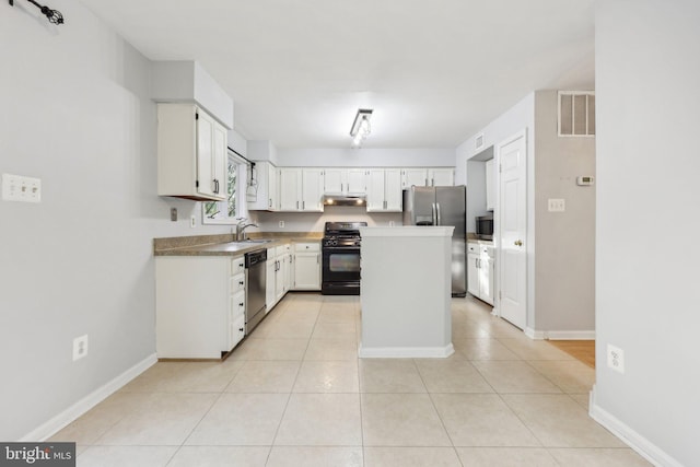 kitchen featuring stainless steel appliances, under cabinet range hood, a kitchen island, a sink, and visible vents