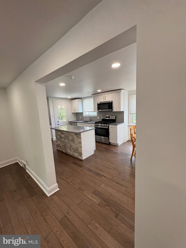 7915 New Second St, Elkins Park, PA 19027 - kitchen with stainless steel appliances, dark wood-style floors, white cabinetry, decorative backsplash, and recessed lighting