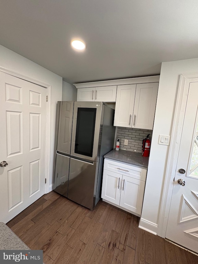 7915 New Second St, Elkins Park, PA 19027 - kitchen featuring dark wood-type flooring, white cabinetry, decorative backsplash, and dark countertops