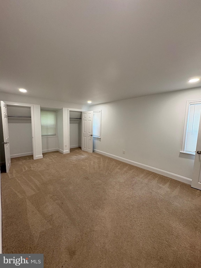 7915 New Second St, Elkins Park, PA 19027 - unfurnished bedroom with light carpet, baseboards, multiple closets, and recessed lighting