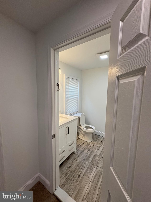 7915 New Second St, Elkins Park, PA 19027 - half bathroom featuring vanity, toilet, wood finished floors, and baseboards
