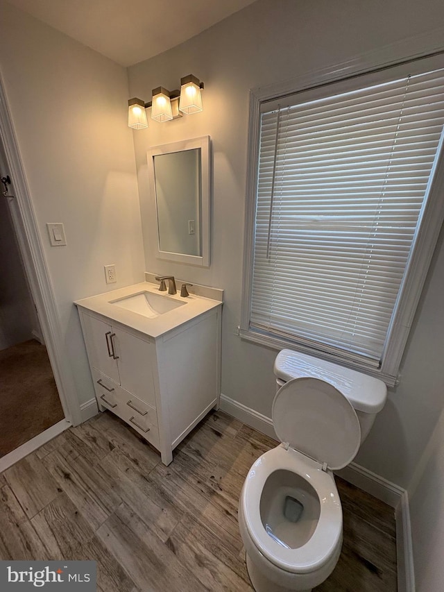 7915 New Second St, Elkins Park, PA 19027 - bathroom with wood finished floors, vanity, toilet, and baseboards
