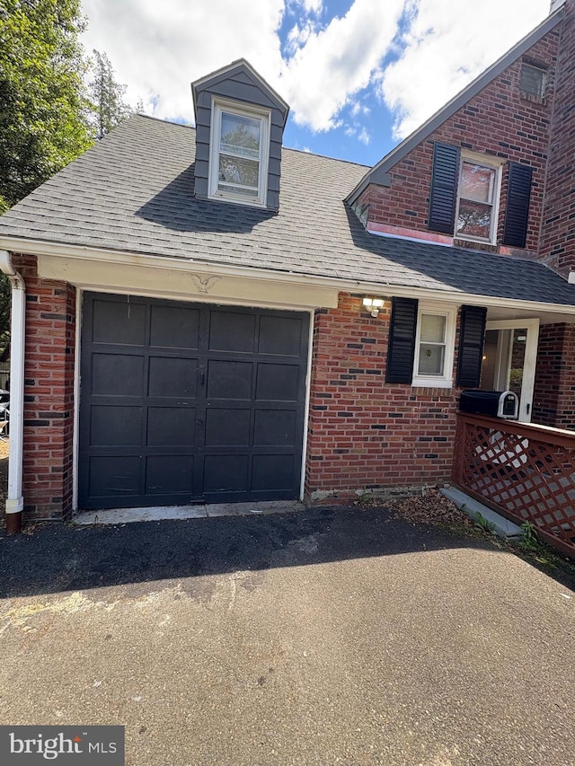 7915 New Second St, Elkins Park, PA 19027 - view of front of property with brick siding, a shingled roof, and asphalt driveway