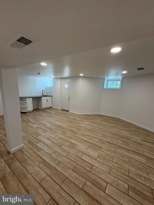 7915 New Second St, Elkins Park, PA 19027 - basement with light wood finished floors, recessed lighting, baseboards, and a sink