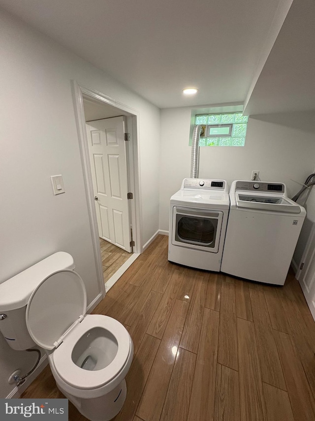 7915 New Second St, Elkins Park, PA 19027 - washroom with washer and clothes dryer, wood finished floors, and baseboards