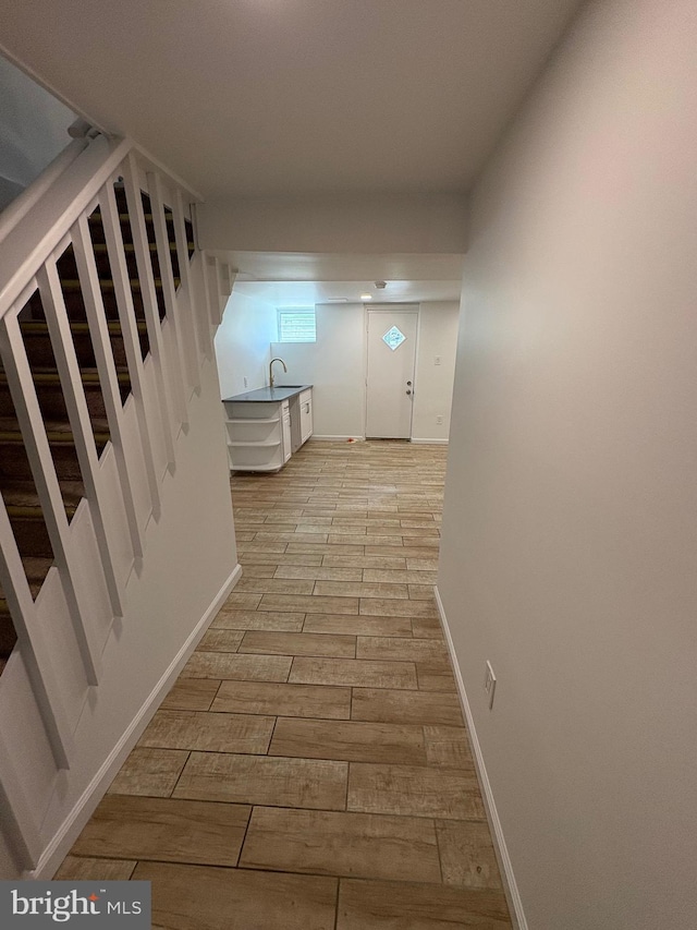 7915 New Second St, Elkins Park, PA 19027 - hall featuring stairs, a sink, light wood-style floors, and baseboards