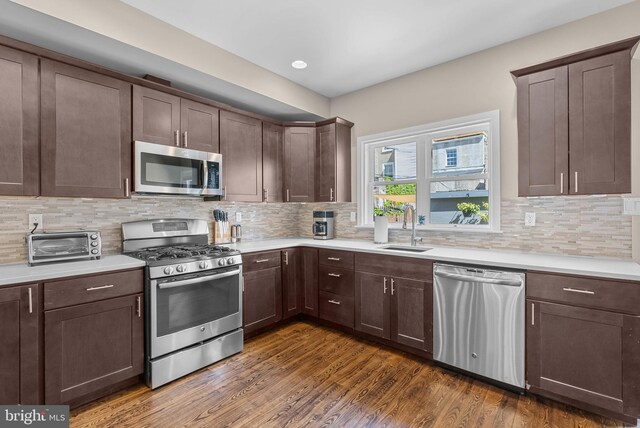 kitchen featuring a toaster, stainless steel appliances, and light countertops