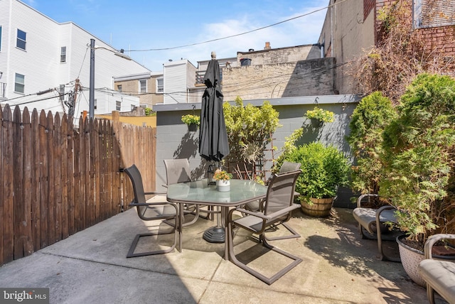 view of patio featuring fence and outdoor dining area