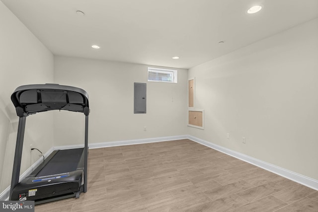 workout area featuring recessed lighting, electric panel, and baseboards
