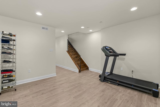 exercise room featuring recessed lighting and light wood-style floors