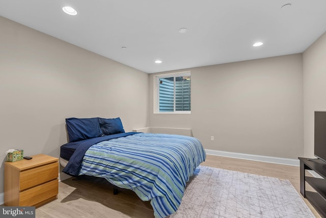 bedroom with baseboards, recessed lighting, and wood finished floors