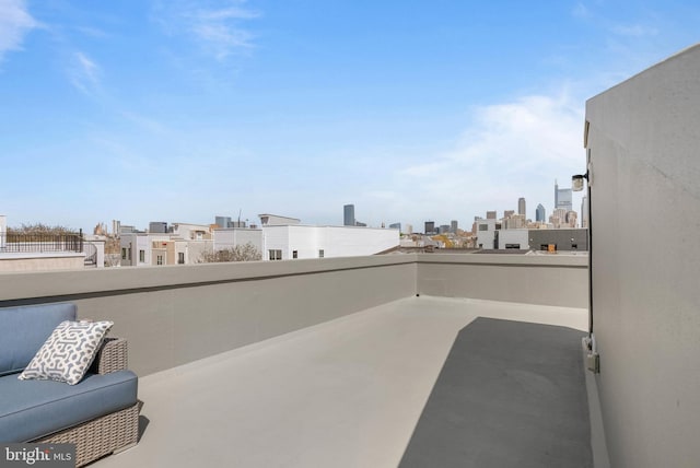view of patio / terrace with a view of city and a balcony