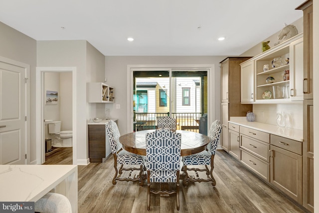 dining room featuring wood finished floors, recessed lighting, and baseboards