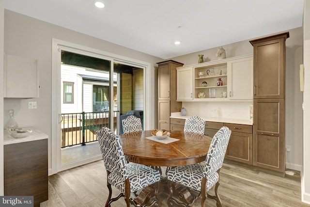dining area featuring light wood-style flooring and recessed lighting