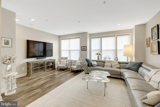 living area featuring wood finished floors, recessed lighting, and baseboards