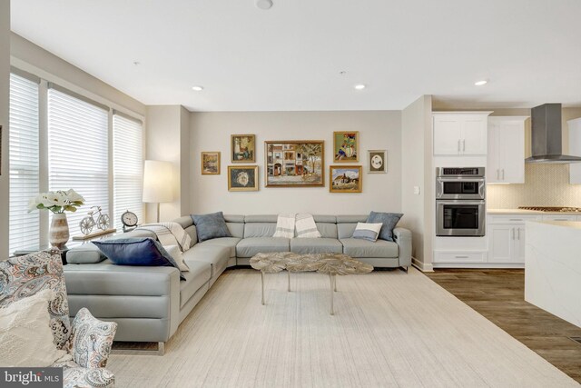 living room with wood finished floors and recessed lighting