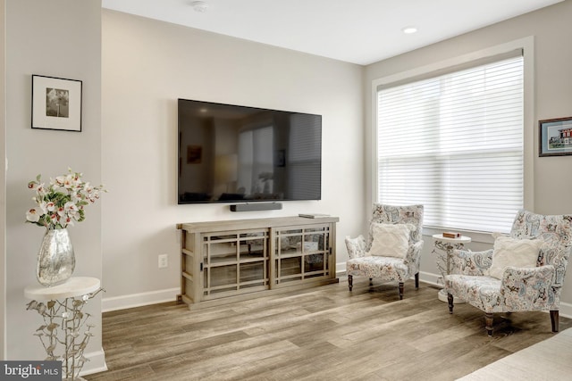 sitting room featuring wood finished floors, baseboards, and recessed lighting