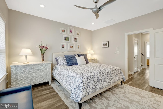bedroom featuring wood finished floors, baseboards, ceiling fan, and recessed lighting