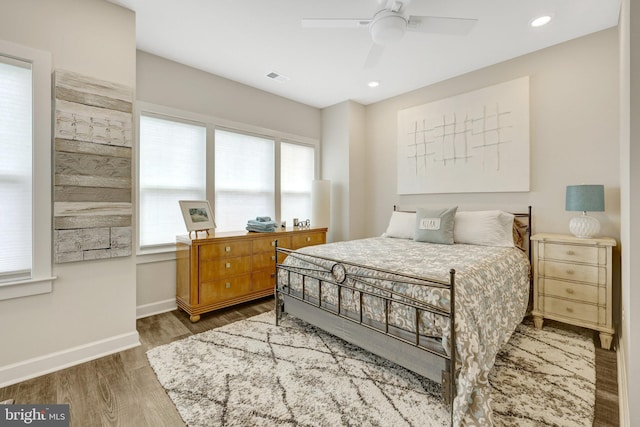 bedroom with wood finished floors, baseboards, a ceiling fan, and recessed lighting