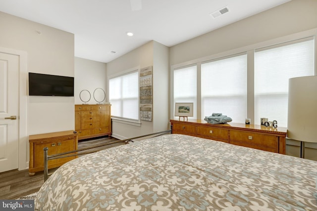 bedroom featuring dark wood-type flooring and recessed lighting
