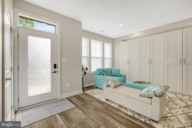 foyer entrance featuring light wood-style floors, baseboards, and recessed lighting