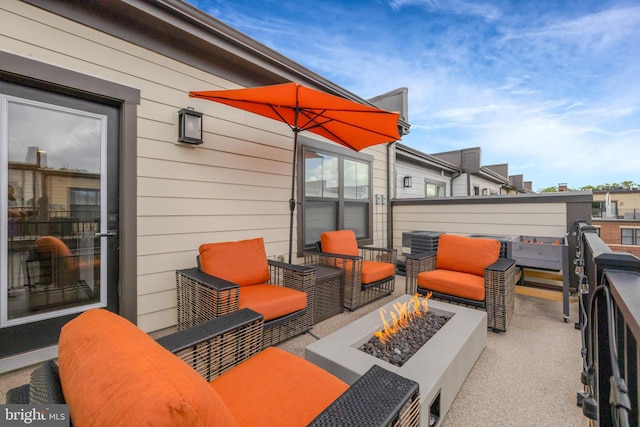 view of patio with an outdoor living space with a fire pit and central AC