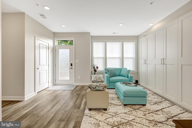 living area featuring wood finished floors, baseboards, and recessed lighting