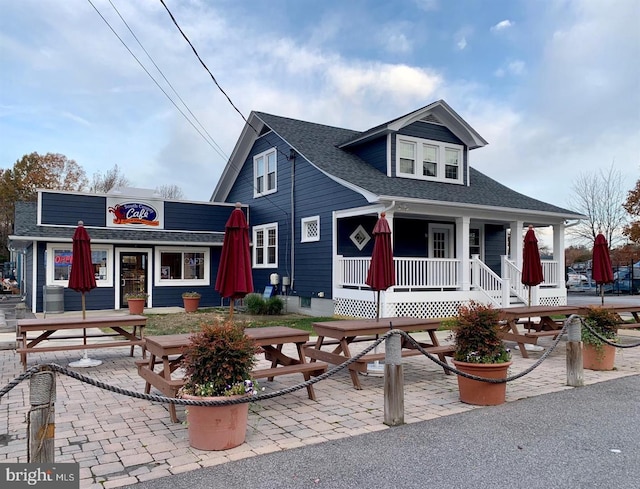 view of front of house featuring a porch and a shingled roof