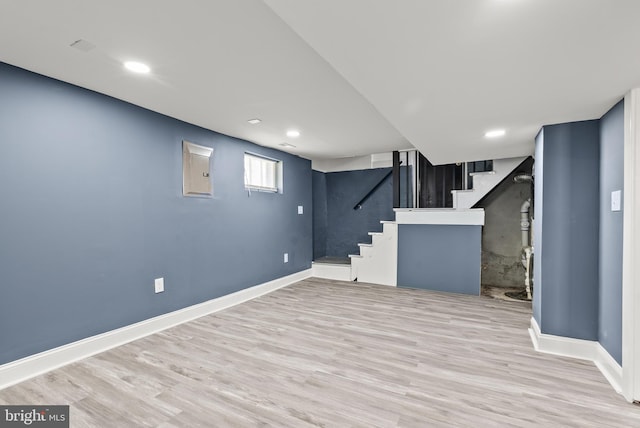 basement with baseboards, recessed lighting, wood finished floors, and stairs