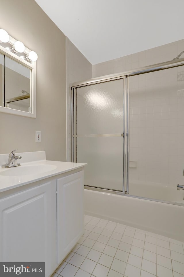 full bathroom featuring tile patterned flooring, enclosed tub / shower combo, and vanity