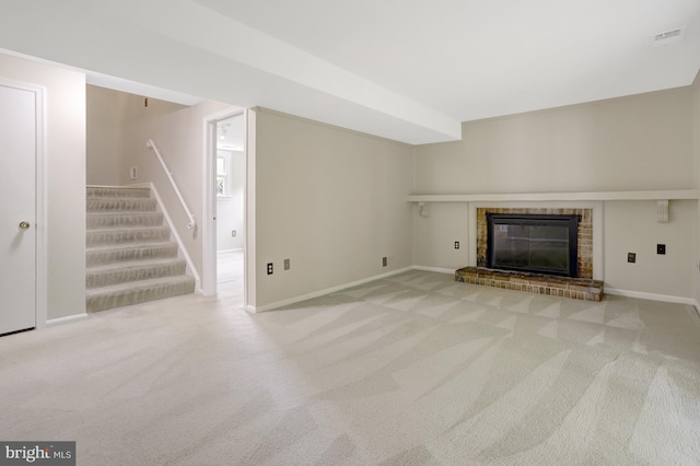 unfurnished living room with baseboards, a fireplace, carpet flooring, and stairs