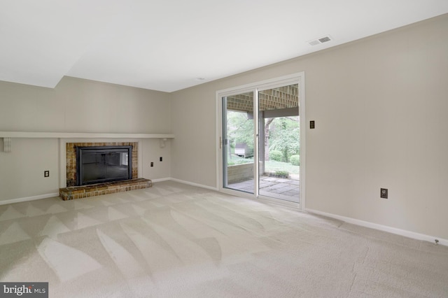 unfurnished living room featuring carpet floors, baseboards, visible vents, and a fireplace