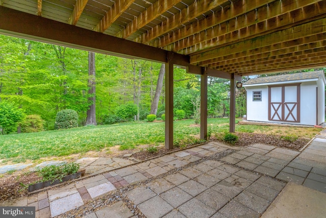 view of patio with an outbuilding and a shed