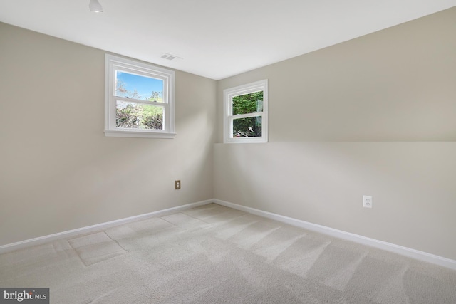 carpeted empty room with baseboards and visible vents