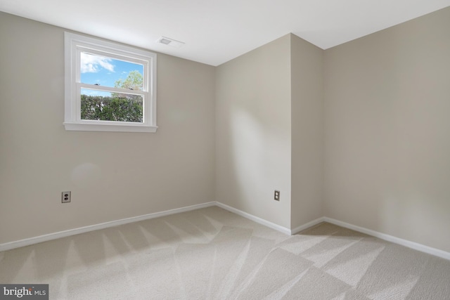 unfurnished room with visible vents, baseboards, and light carpet